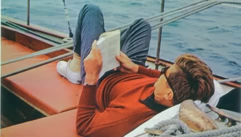 JFK reading on a boat